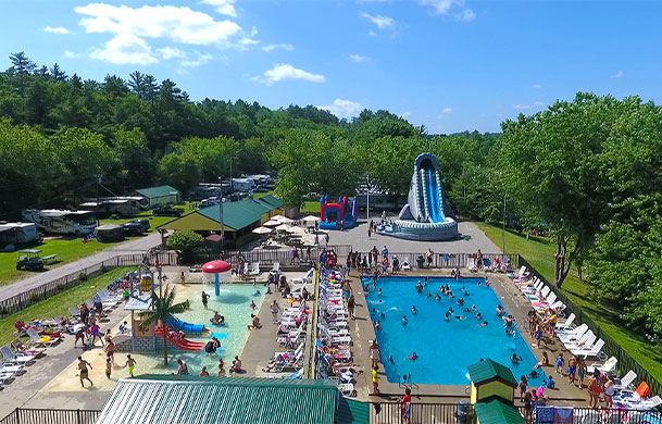 aerial view of swimming pool, splash park and inflatable water slide